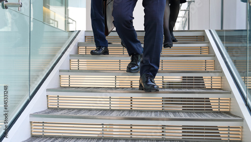 Fotografija Group of business people walking up the stairs