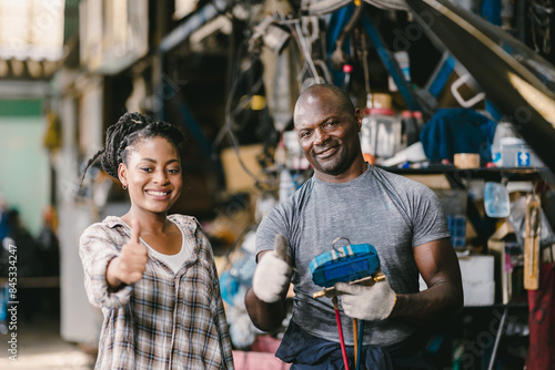 Happy customer standing Thumbs up with mechanic man fix car problem. Satisfied garage car service.