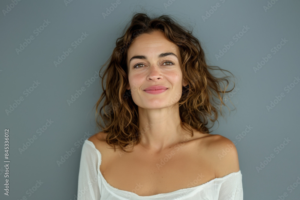 A close up portrait of a woman with a subtle smile A close up portrait of a woman with a subtle smile