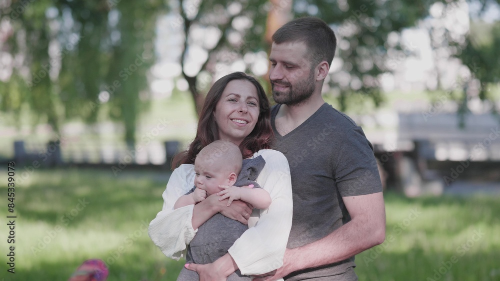 mom dad and little child summer portrait in the park mom dad and little child summer portrait in the park