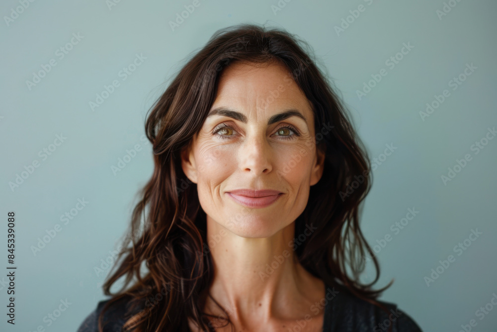 A close up portrait of a woman with a subtle smile A close up portrait of a woman with a subtle smile