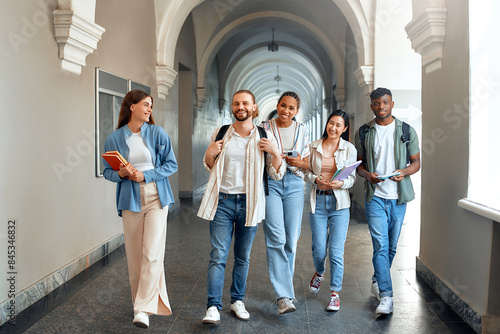 Photography Students walking in university hallway, showing friendship, collaboration, acade