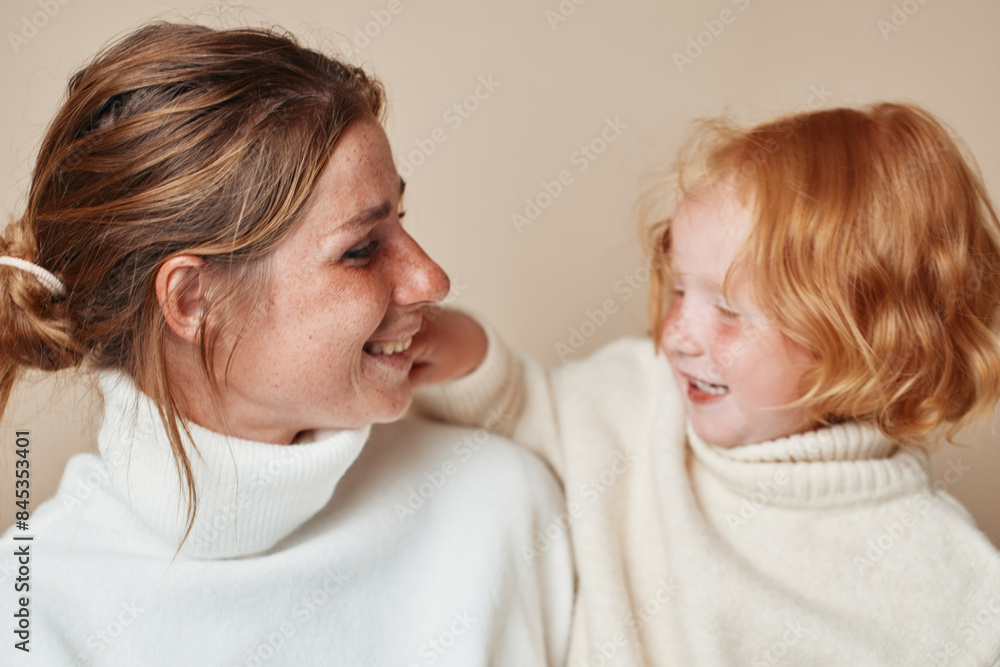 Mother and daughter smiling together in a beautiful moment of love and connection on a summer day Mother and daughter smiling together in a beautiful moment of love and connection on a summer day