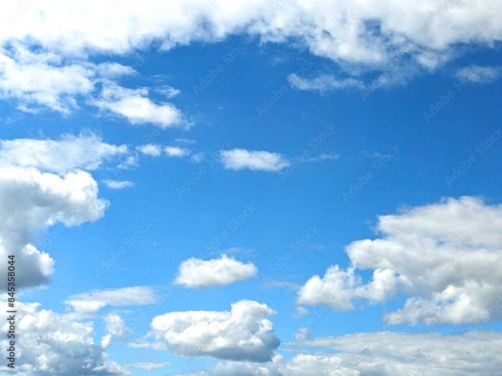 Fototapeta premium Fluffy White Clouds in a Blue Sky as A Skyscape Background