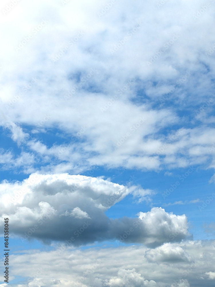 Fluffy White Clouds in a Blue Sky as A Skyscape Background Fluffy White Clouds in a Blue Sky as A Skyscape Background