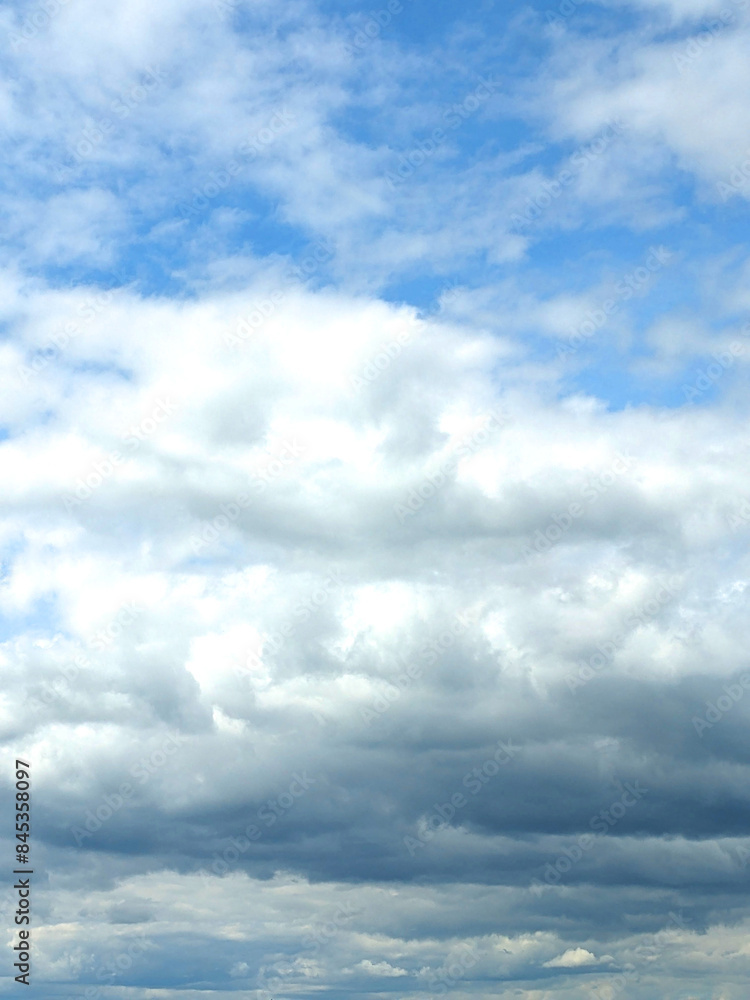 Fluffy White Clouds in a Blue Sky as A Skyscape Background Fluffy White Clouds in a Blue Sky as A Skyscape Background