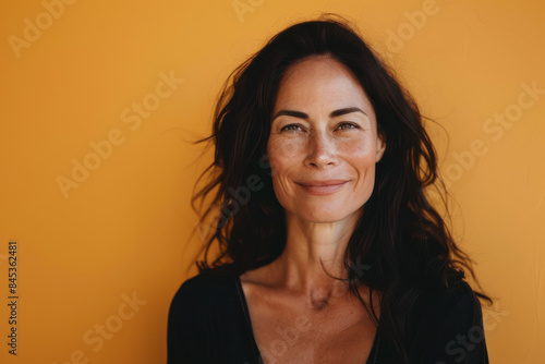 A close up portrait of a woman with a subtle smile