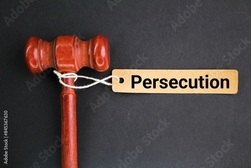 Photos judge's hammer and a paper tag with the word persecution