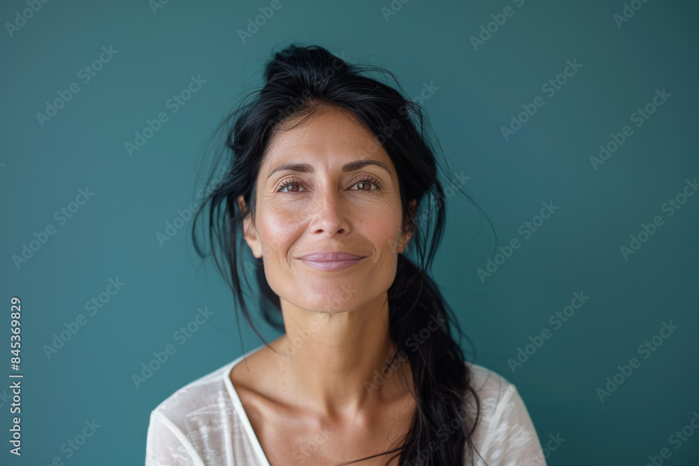 A close up portrait of a woman with a subtle smile A close up portrait of a woman with a subtle smile