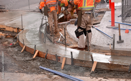 construction crew replaces the corner sidewalk