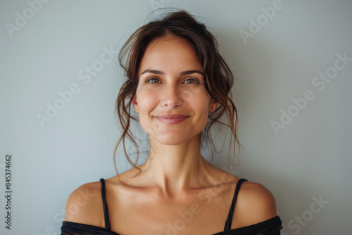 A close up portrait of a woman with a subtle smile