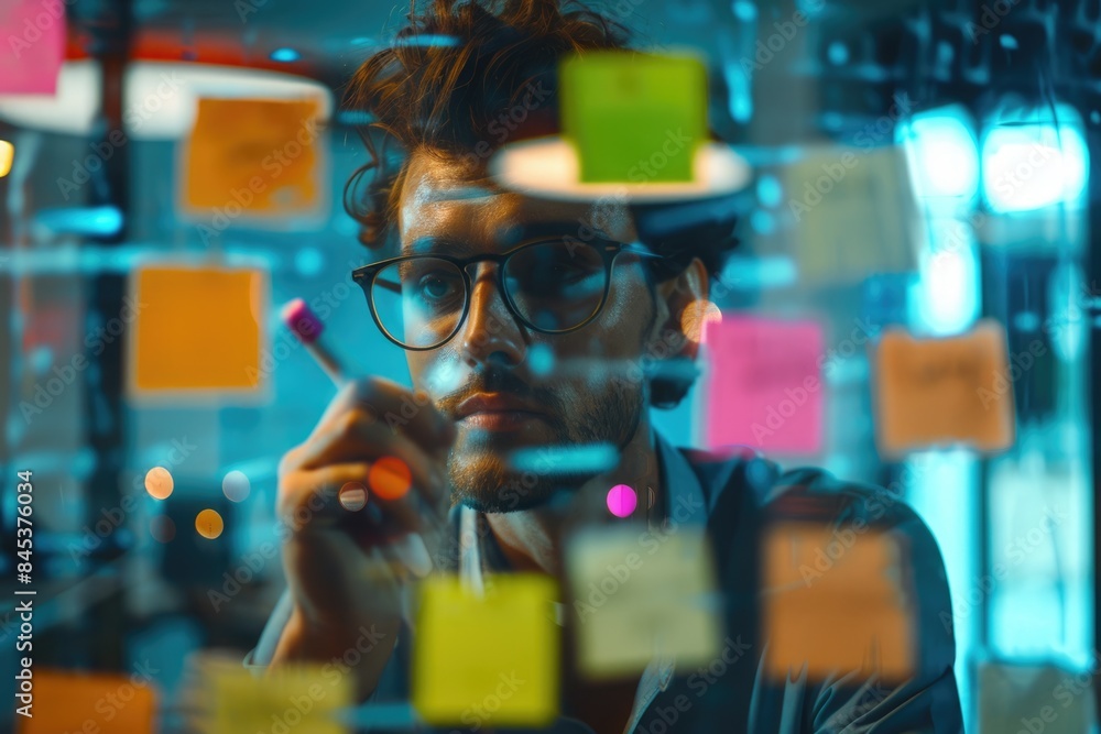 Young businessman brainstorming and formulating business strategies in office. Young businessman brainstorming and formulating business strategies in office.