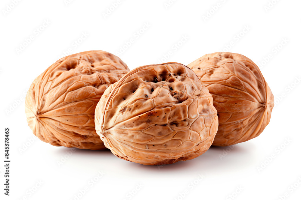 Close-up of shelled and unshelled Walnut nuts isolated on a white background, showcasing their texture Close-up of shelled and unshelled Walnut nuts isolated on a white background, showcasing their texture