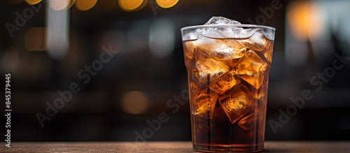 Black charcoal cold drink in glass selective focus. Creative banner. Copyspace image