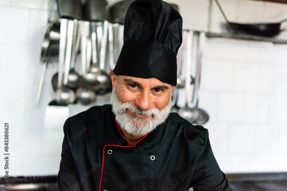 Smiling chef in professional kitchen Smiling chef in professional kitchen