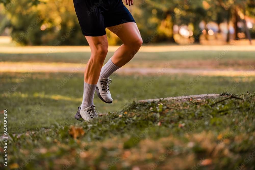 Sport running man in cross country trail run.