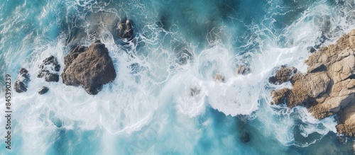 Top view of sea waves hitting rocks Aerial view of sea water and beach coast with stones. Creative banner. Copyspace image