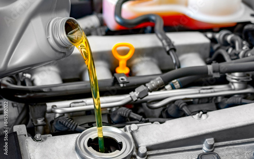 Fresh motor oil pouring car engine