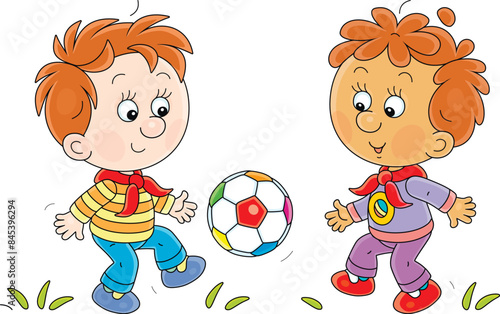 Funny little boys merrily playing football on a playground in a park on a summer vacation, vector cartoon illustration isolated on a white background