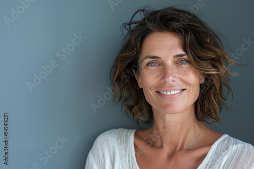 A close up portrait of a woman with a subtle smile