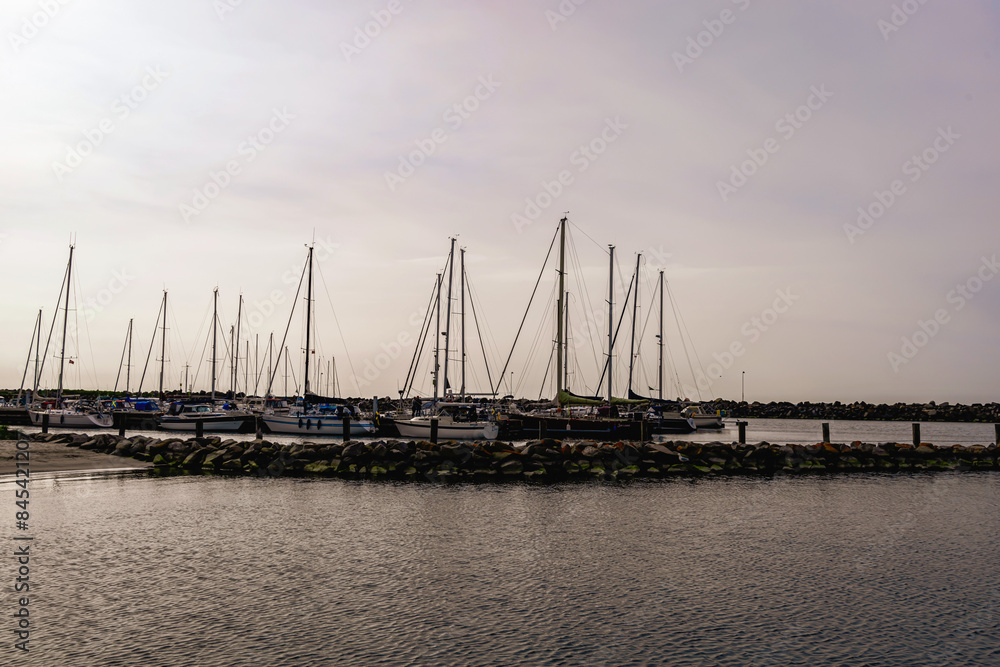 Sea pier with boats and yachts at sunset. Bornholm, Denmark