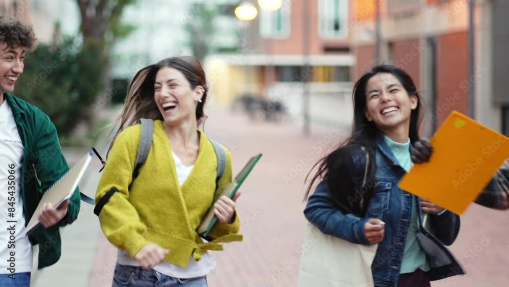 Group of students running in the campus going to college school celebrating University graduation Group of students running in the campus going to college school celebrating University graduation