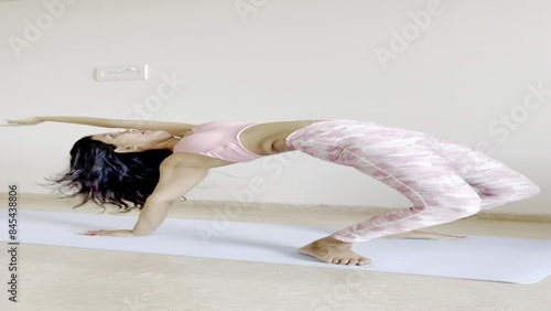 Video Clip Of A Fitness Instructor Doing malasana and chakrasana.