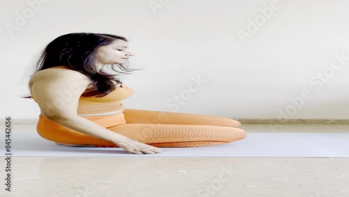 A Video Of A Slim Female Performing lion pose in yoga (Simhasana).
