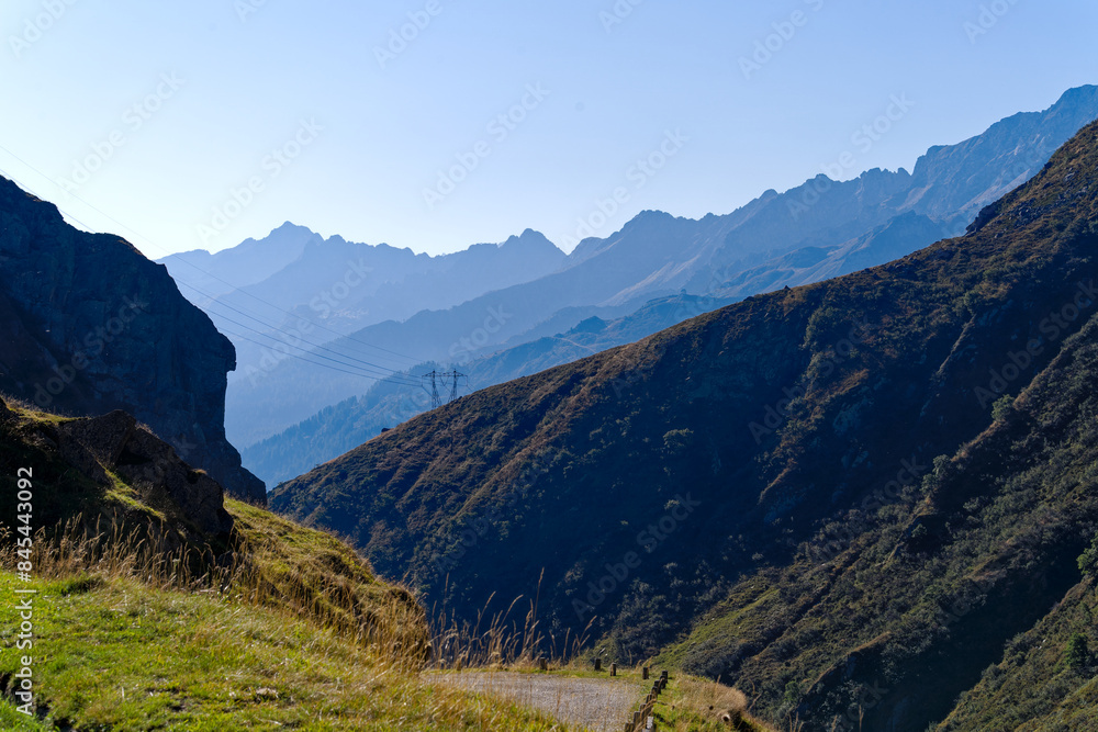Fototapeta premium Scenic view of mountain pass road named Tremola at Swiss mountain pass Gotthard on a sunny late summer day. Photo taken September 10th, 2023, Gotthard, Canton Ticino, Switzerland.