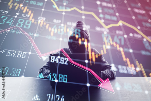 Tableau sur toile A person in a hoodie using a laptop with a double exposure of declining financia