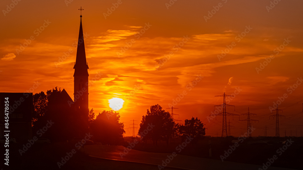 Sunset with a church silhouette near Wallerdorf, Künzing, Deggendorf, Bavaria, Germany