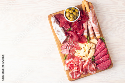 Charcuterie board. Antipasti appetizers of meat and cheese platter with salami, prosciutto crudo or jamon and olives