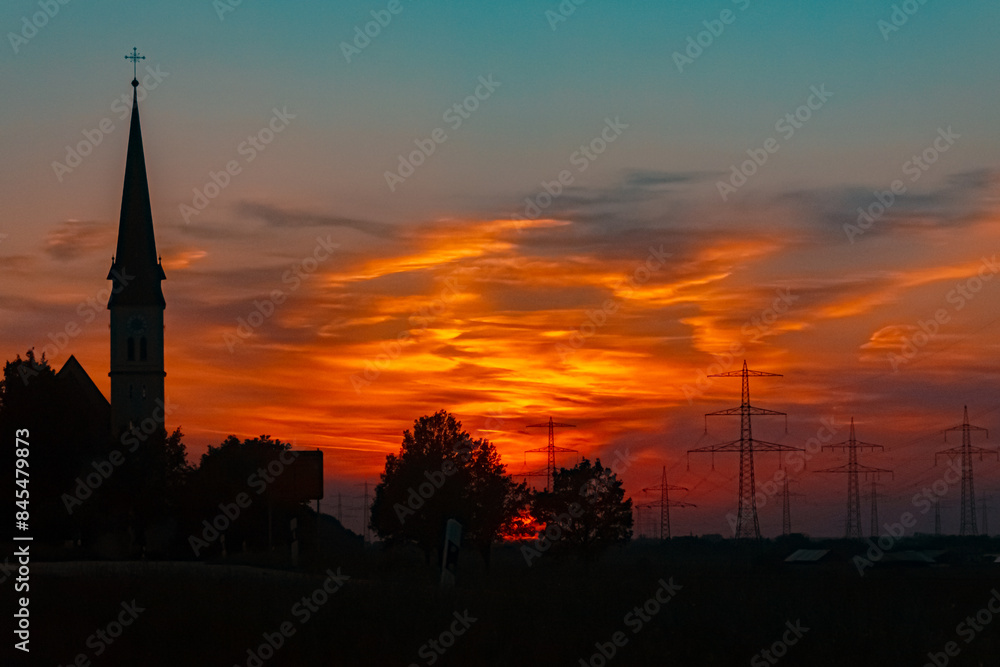 Sunset with a church silhouette near Wallerdorf, Künzing, Deggendorf, Bavaria, Germany