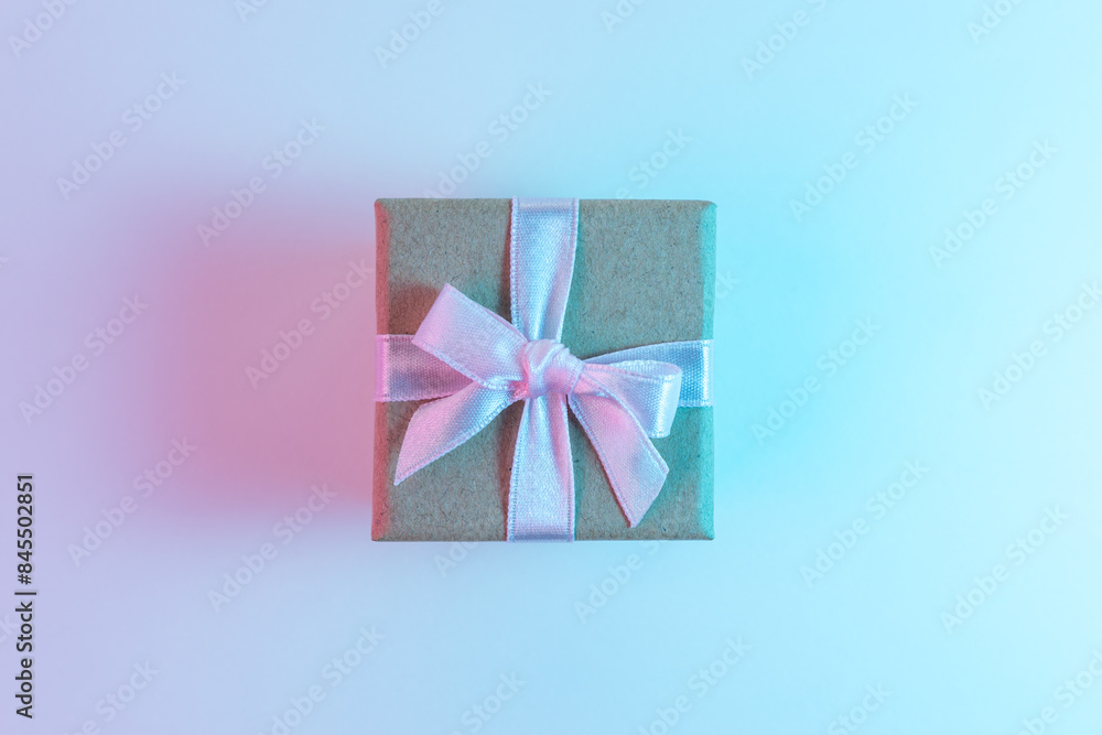 Gift box in vibrant bold gradient holographic colors. Christmas and New Year minimal art concept. Gift box in vibrant bold gradient holographic colors. Christmas and New Year minimal art concept.