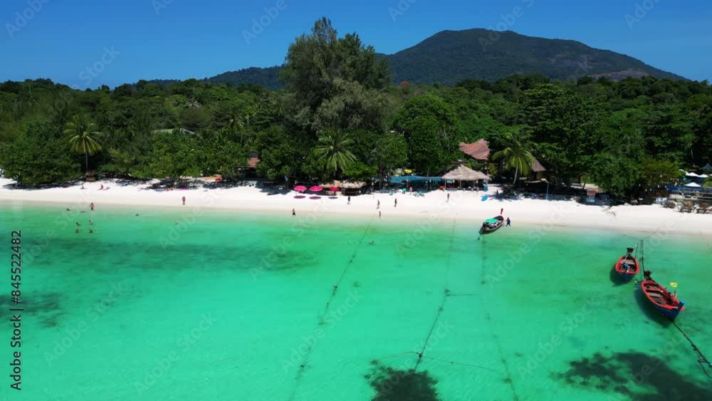 Relaxing on sandy beach with longtail boats. Smooth aerial view flight drone Relaxing on sandy beach with longtail boats. Smooth aerial view flight drone