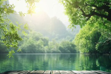 Tranquil lake with lush green trees and mountains in the background, sunlight streaming through foliage, wooden deck in the foreground.