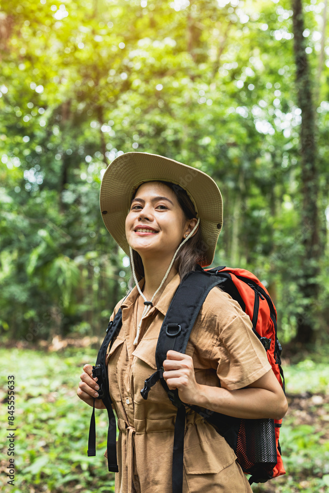Close up of young Asian woman backpacker traveling alone in forest wild during vacation trip. Close up of young Asian woman backpacker traveling alone in forest wild during vacation trip.
