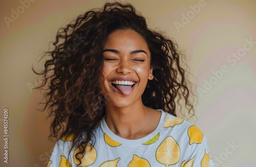 Young Woman With Curly Hair Smiling and Sticking Out Her Tongue