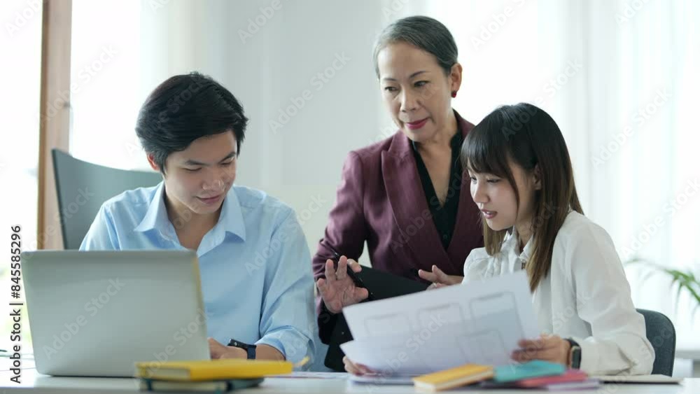 Group of asian business people working together, brainstorming in office Group of asian business people working together, brainstorming in office