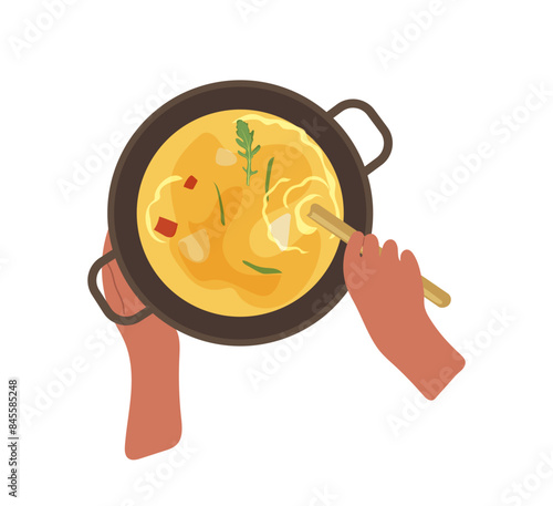 Human hands cooking cream soup in kitchen pot view from above isolated on white background