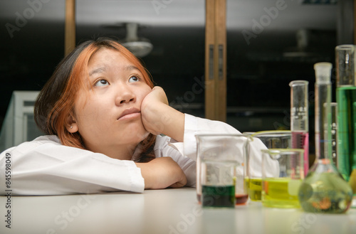 Dreaming little girl at the chemistry laboratory, scientist and education