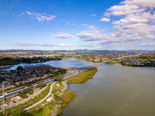 Main road in South Auckland in afternoon sun with clouds and blue sky. 