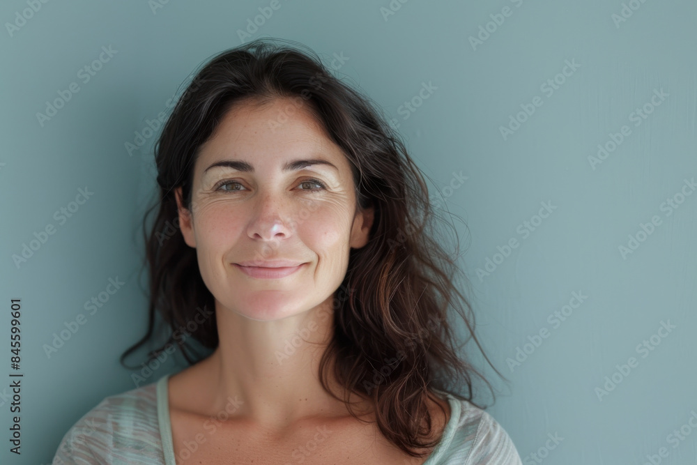 A close up portrait of a woman with a subtle smile A close up portrait of a woman with a subtle smile