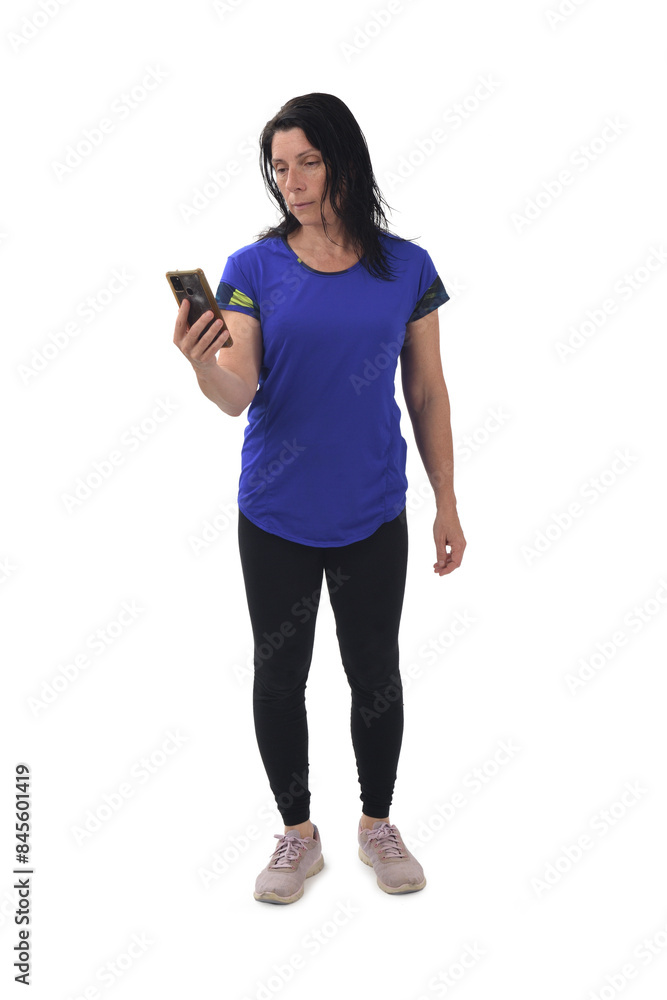 front view of a standing woman looking at her mobile phone on white background front view of a standing woman looking at her mobile phone on white background