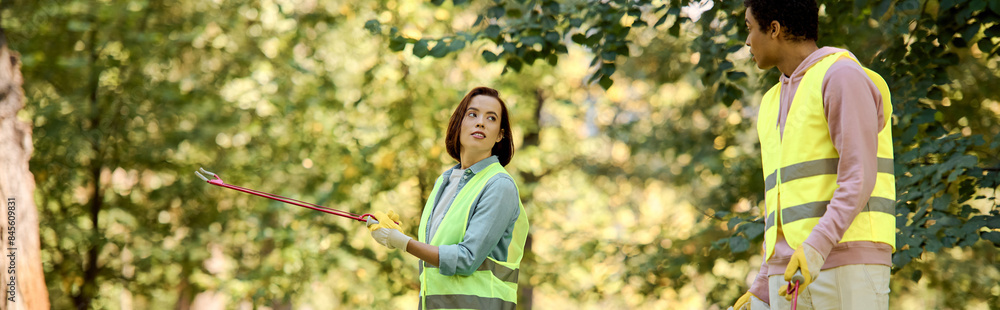 A diverse loving couple, clad in safety vests and gloves, standing in the serene woods. A diverse loving couple, clad in safety vests and gloves, standing in the serene woods.