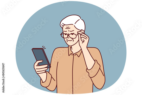 Elderly man with poor eyesight squint looking at screen of mobile phone to read SMS. Grandpa is having vision problems due to cataracts in eyes and needs help of ophthalmologist doctor