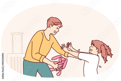 Little girl runs to father who returned from long business trip with gift and wants to hug daughter. Man with toy hare in hand stands near suitcase and rejoices when he sees daughter running towards
