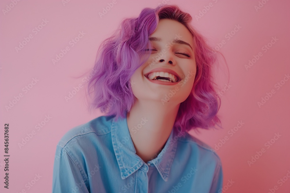 Joyful Young Woman with Purple Hair Laughing on Pink Background Joyful Young Woman with Purple Hair Laughing on Pink Background