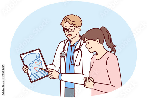 Man plastic surgeon consults woman patient demonstrating tablet with ways to tighten skin on face to get rid of wrinkles. Girl turned to plastic surgeon for help to do facial surgery