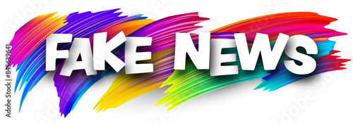 Fake news paper word sign with colorful spectrum paint brush strokes over white.